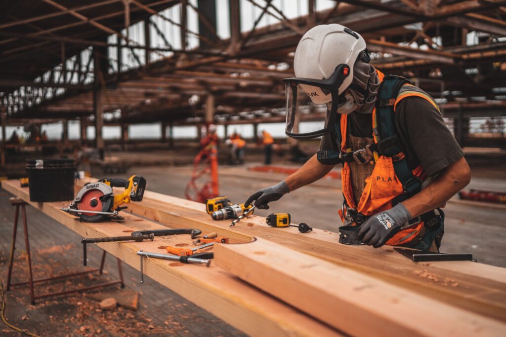 A construction worker using tools on a job site