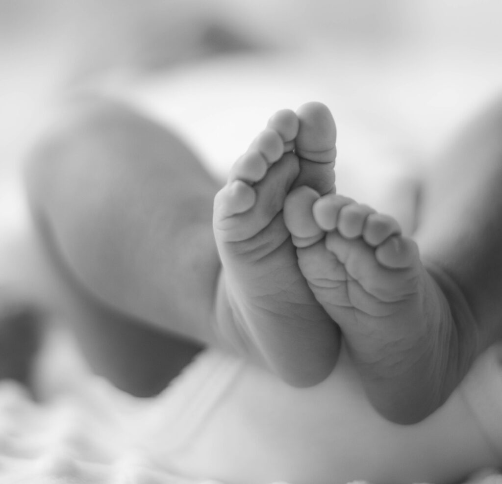 Black and white image of a newborn baby's feet